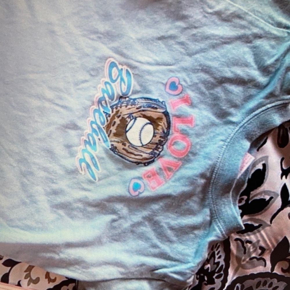 Features fun baseball graphic with stylish baby’s top